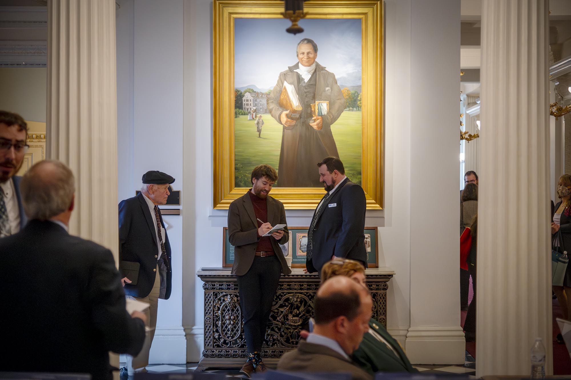 A photo of Shaun Robinson interviewing an activist inside the Vermont State House.
